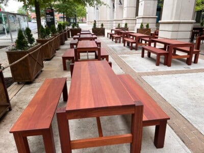 outside dining area with hardwood benches and tables