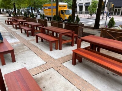outside dining area with hardwood benches and tables