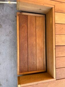 Premium Ipe decking boards with rich grain texture, featuring tight joints and a smooth surface finish, perfect for outdoor spaces.