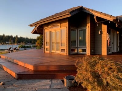 An ipe deck wrapping around a house.