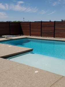 pool with a hardwood fence around it