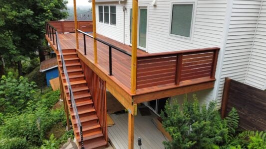 Batu deck built by AB Construction LLC with DW Construction LLC Batu deck and railing with stairs leading up to it.